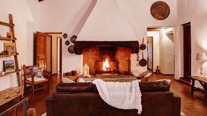 A cozy living room with a fireplace, wooden furniture, and a rustic decor. - Secluded villa between Chianti vineyards, private pool, tennis, large garden (Gaiole In Chianti)