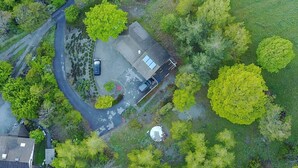 An aerial view of a residential area with a house, a driveway, and surrounding greenery. - Great mountain villa (7 parts): skiing, lake and sun !- St André d''EMBRUN (Embrun)