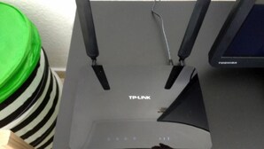 A TP-Link router with a Toshiba monitor beside it.