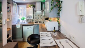 A modern kitchen with a dining area set for two.