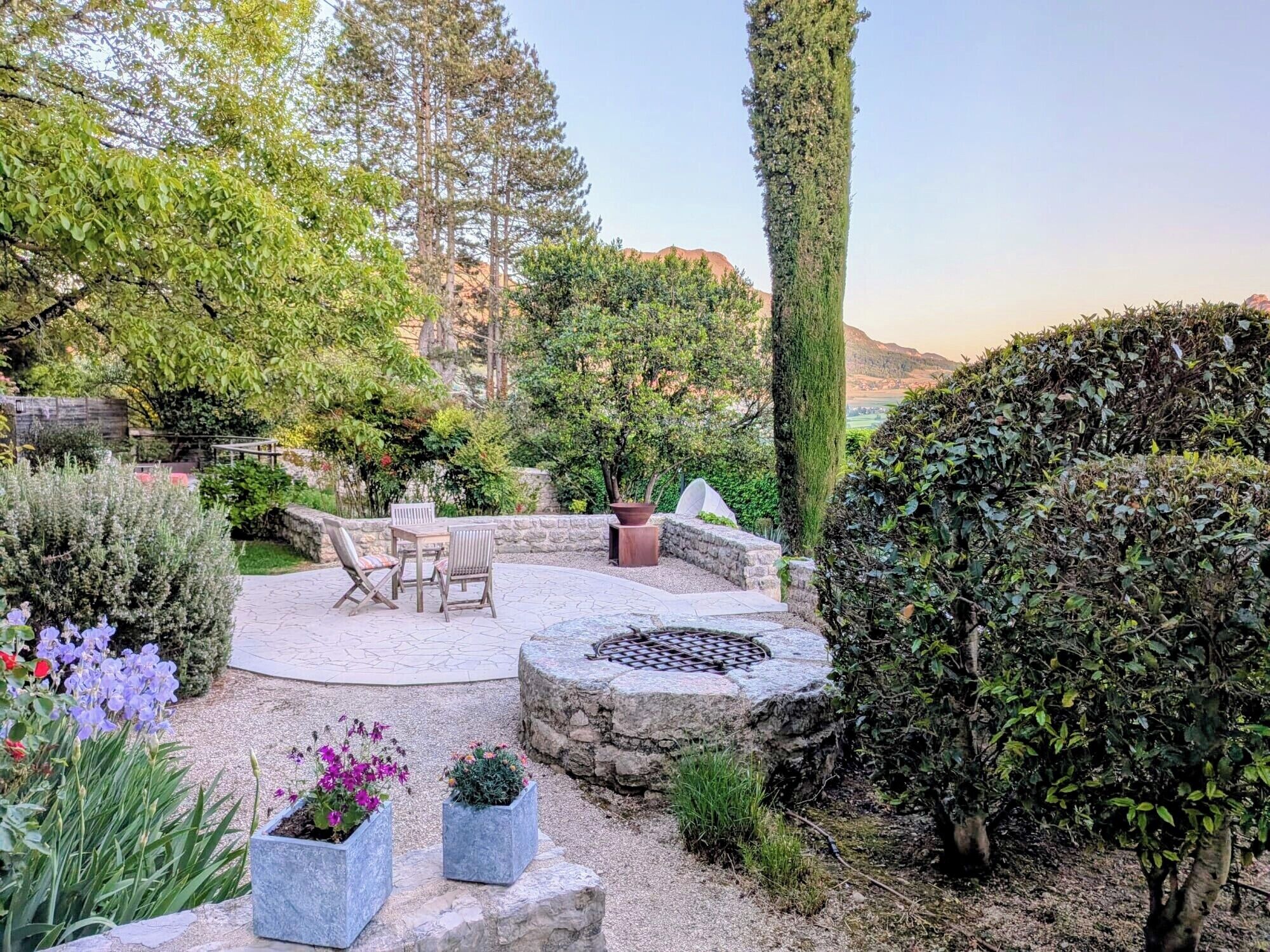 A patio area with stone flooring, a fire pit, and outdoor furniture.