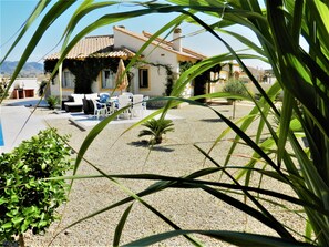 A house with a patio area, outdoor furniture, and a pool. - Beautiful Modern Villa, ESP & UK TV, WIFI, Aircon, Private Designer Pool & Golf  (Mazarrón)