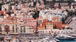 A marina with multiple boats docked, surrounded by a densely packed urban area with various buildings. - STUNNING BEACHFRONT APARTMENT ON PROMENADE,  ENDLESS SEAVIEWS, SUPERB LOCATION  (Nice)