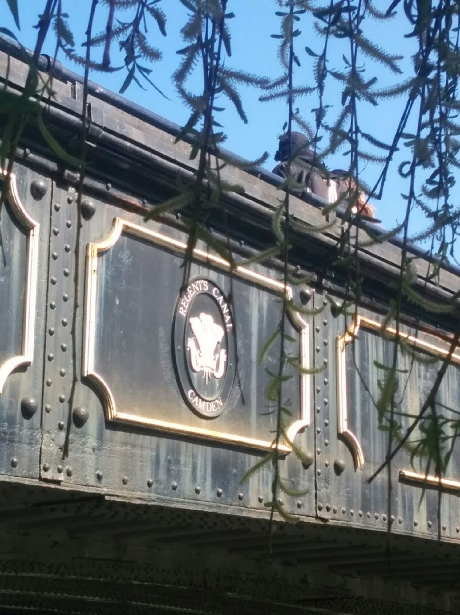 A metal structure with rivets and a plaque that reads "Regent's Canal Camden."
