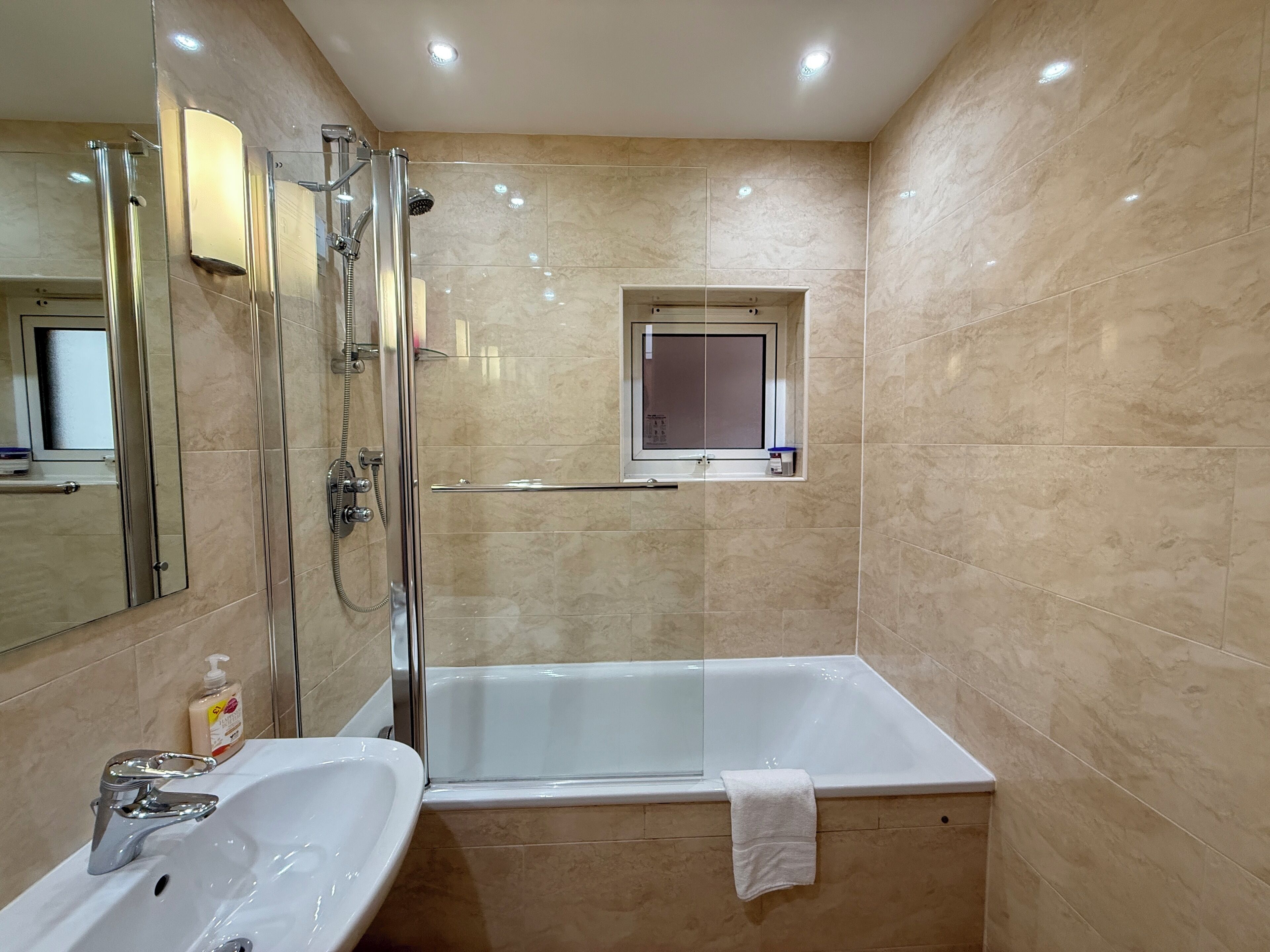 Combined shower/tub, hair dryer, towels, soap