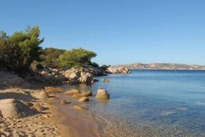A clear beach with rocks and sparse vegetation. - Porto Rafael, wonderful villa 3 rooms e 3 bathroom (Punta Sardegna)