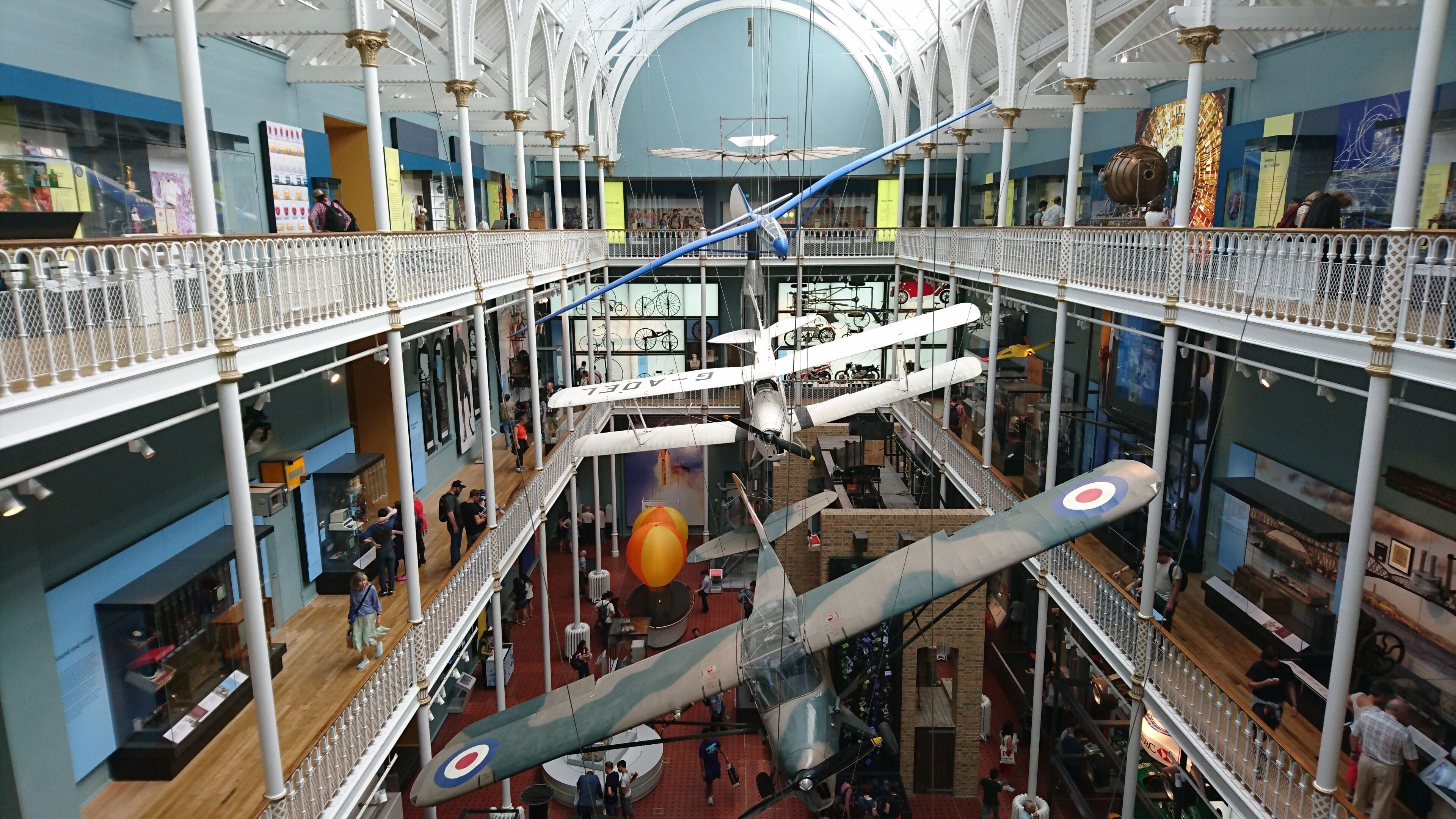 A multi-level atrium with a large aircraft model suspended in the center.