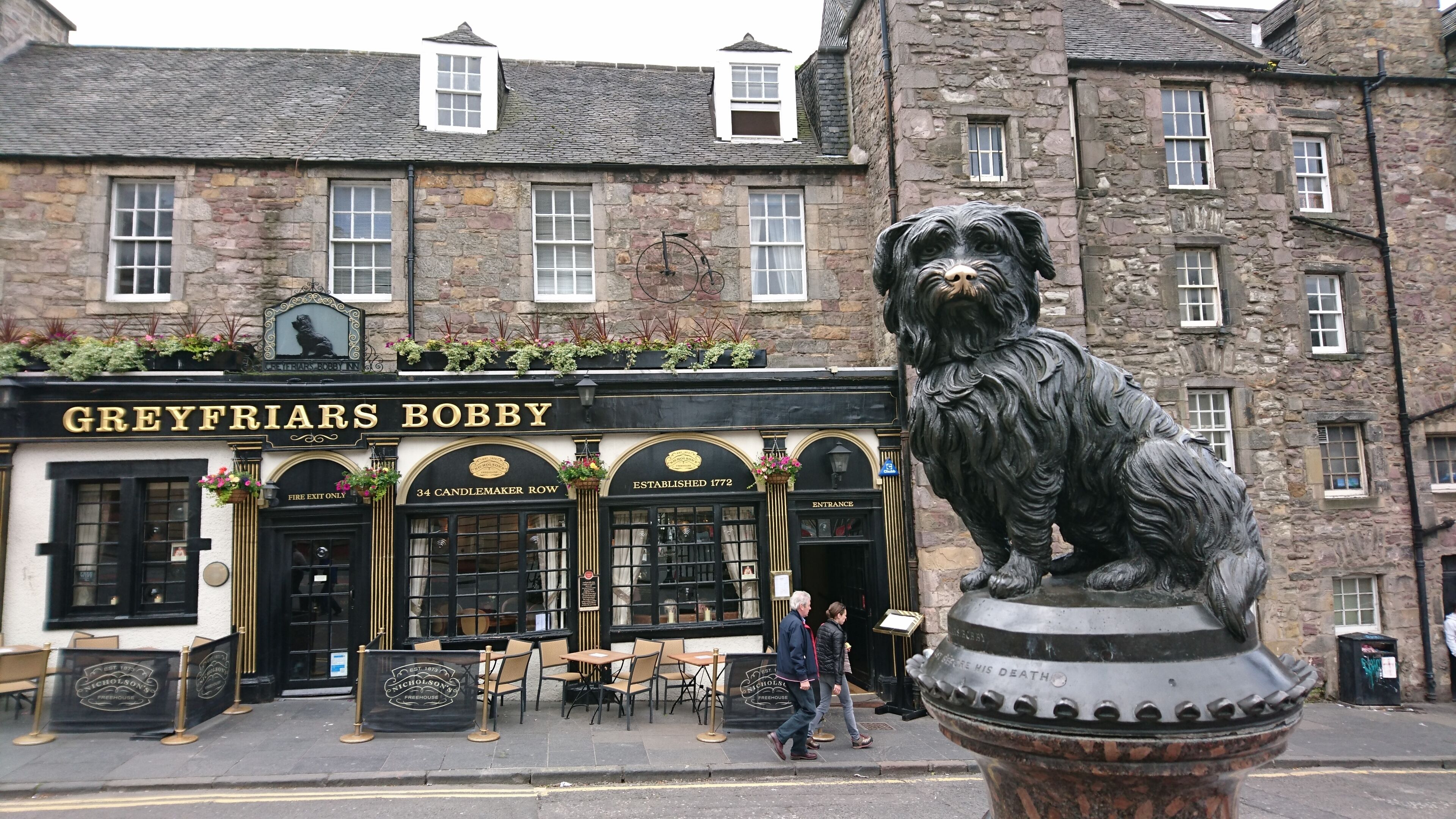 A pub named 'Greyfriars Bobby' with a lion statue in front.