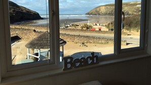 A beach view through a window with a sign reading "Beach".