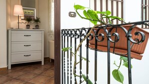 A white dresser with drawers, a lamp, and potted plants. - Finocchiaro Penthouse - Terrace in the Center WiFi Free (Palermo)