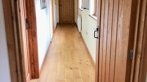 A hallway with wooden doors and a radiator on the wall.