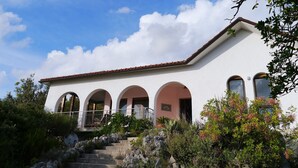 A white building with a red-tiled roof, three arched doorways, and a staircase leading up to the entrance. - Total Peace, Quiet And Privacy In A Breathtaking Mountainside Location Near Rome (Poggio Catino)