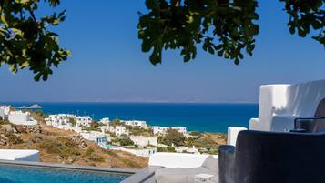 A view of a coastal village with white buildings and a clear blue sky.