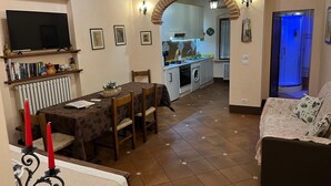 Ein gemütliches Wohnzimmer mit Essbereich, einer Küche und einem Badezimmer.