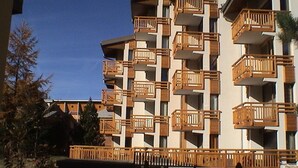 A multi-story hotel with balconies on each floor.