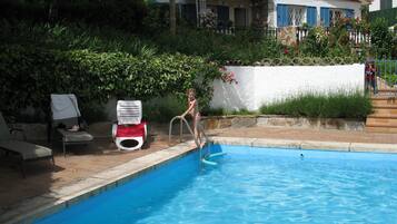 Relax by the pool surrounded by lush gardens and comfortable lounge seating.