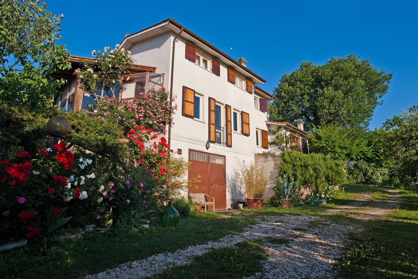 A two-story house with a garden path leading to the entrance.
