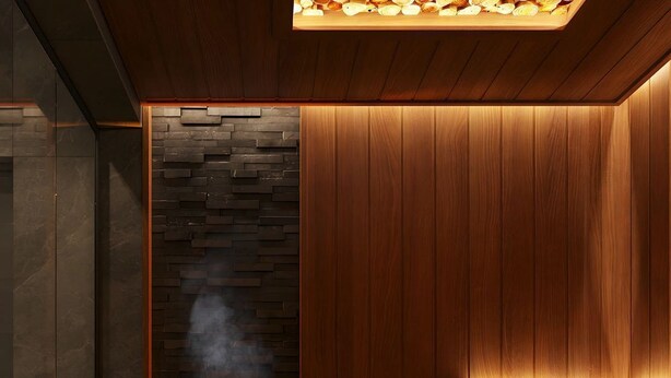 Un sauna avec un mur en pierre, des bancs en bois et une bouche d’aération pour la vapeur.
