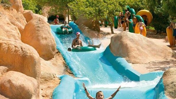 Parque acuático con múltiples toboganes y flotadores inflables.