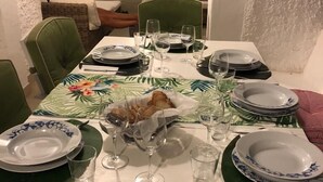 A dining table set with plates, glasses, and cutlery, with a green chair visible. - New villa 2 levels located in a quiet residence and close to services (San Felice Circeo)