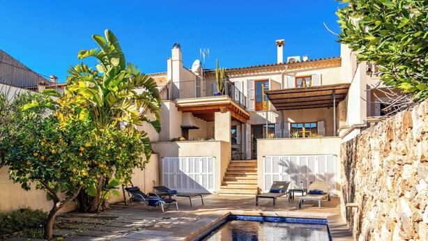 A Mediterranean-style villa with a swimming pool, outdoor seating, and a staircase leading to the upper floor. - Casa Son Bordoi, private pool & tranquility (Llubí)