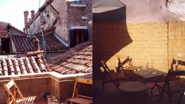 A rooftop terrace with a brick wall and tiled roof, featuring a table and chairs. - Castello apartment with terrace (Venezia)