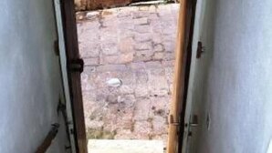 A narrow stairway leading to an outdoor area with a stone floor and a wooden door. - Apartment/ flat - Bonifacio (Bonifacio)