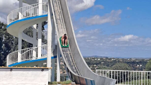 A multi-level water slide structure adjacent to a swimming pool. - Villa with private pool, terrace and sea views (Albufeira)