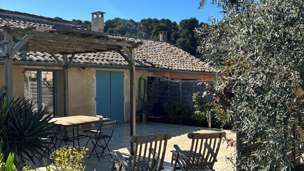 A patio with wooden furniture, a tiled floor, and a pergola. - Spacious Provençal apartment at the heart of an organic vineyard (Vacqueyras)