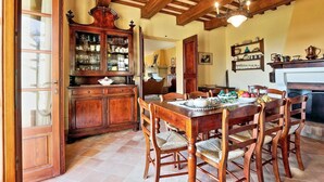 A traditional dining room with a wooden table and chairs, a china cabinet, and a fireplace. - It's pure magic! Dont' miss this unique chance...a beautiful view and an exclusive stay will take yo (Serrapetrona)