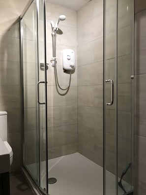 Shower, hair dryer, towels, toilet paper