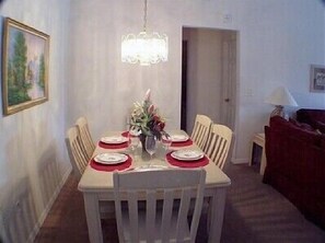 Enjoy meals with family and friends at this dining area, featuring a table for four and comfortable seating.