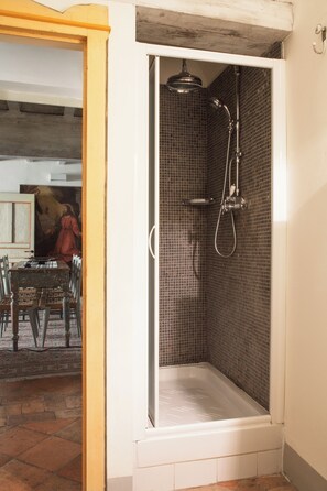 A shower with a tiled wall and a white bathtub. - "Renaissance Retreat" by WP Relais , Palazzo Uguccioni, in Piazza della Signoria (Firenze)