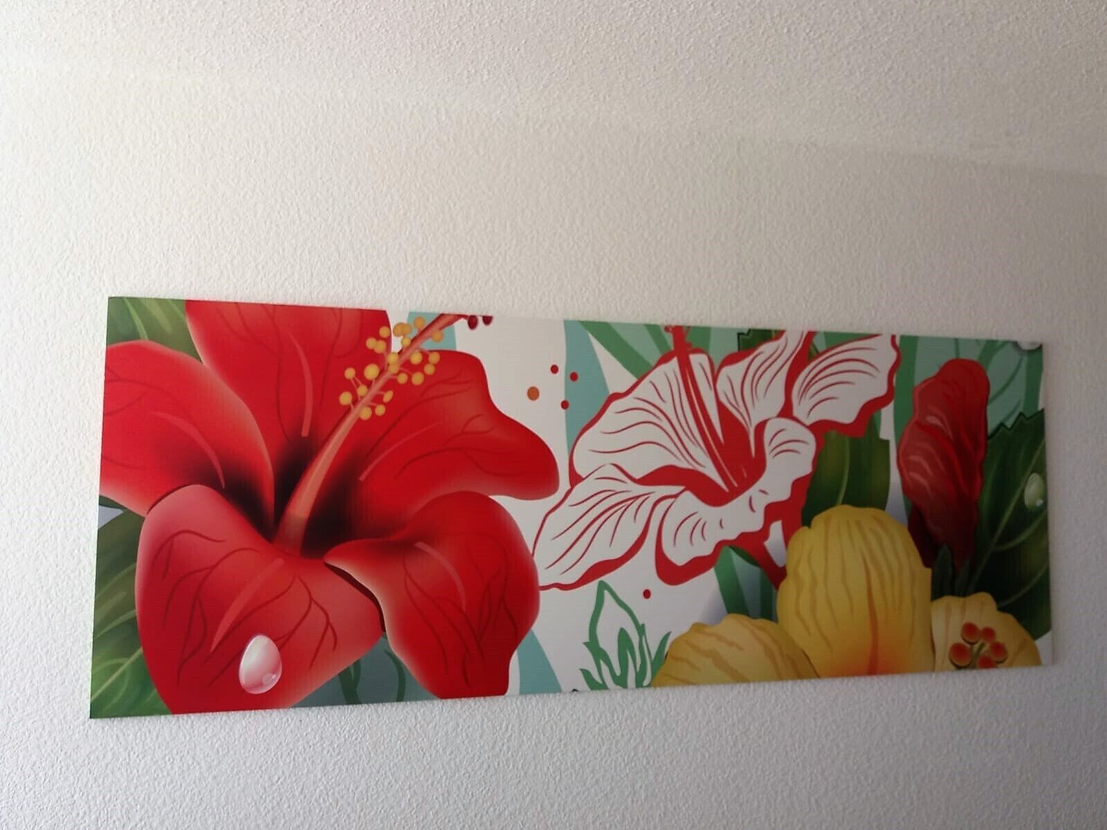 A wall with a floral painting featuring red and yellow flowers.