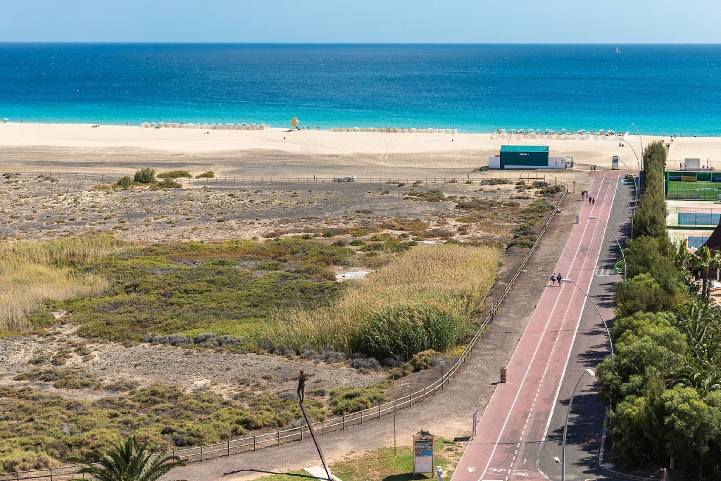 A coastal road with a beach in the background.
