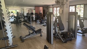 A gym with various exercise equipment, including treadmills, weight machines, and a rowing machine. - Golf, Tennis, Paddle Tennis, Gym, 4 pools including heated, (Ojen)