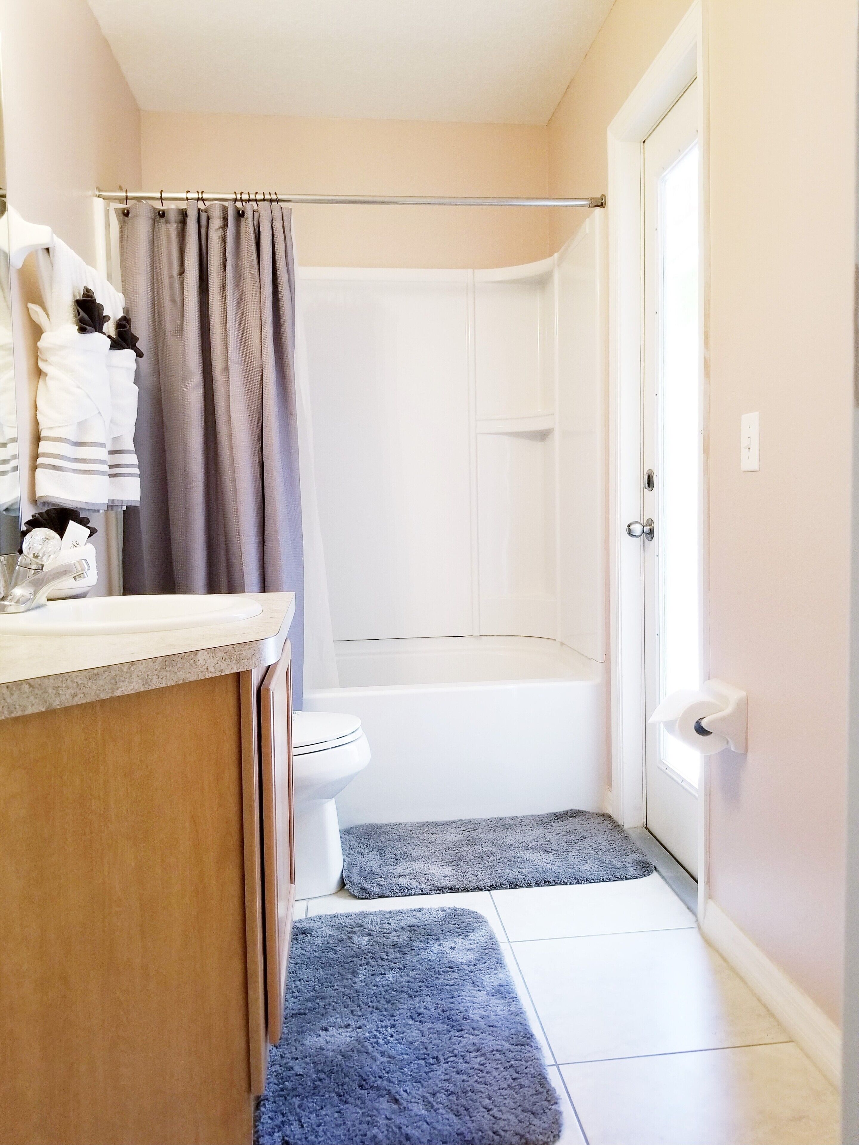 A bathroom with a shower, toilet, and sink.