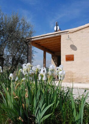 A modern building with a wooden porch and a sign indicating a restaurant. - Charming Countryhouse with huge garden - stunning view - with Heating! (Petritoli)