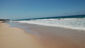 A beach with clear skies and waves. - PRETTY APARTMENT WITH POOL AT BRISTOL SUNSET  (Corralejo)