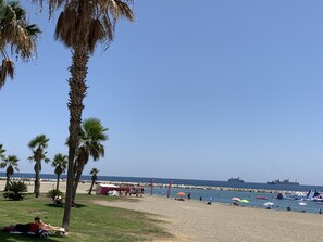 A beach with palm trees, a sandy shore, and a clear blue sky. - Exclusive attic 70sqm,front of Market Atarazanas, great terrace, lift and train (MALAGA)