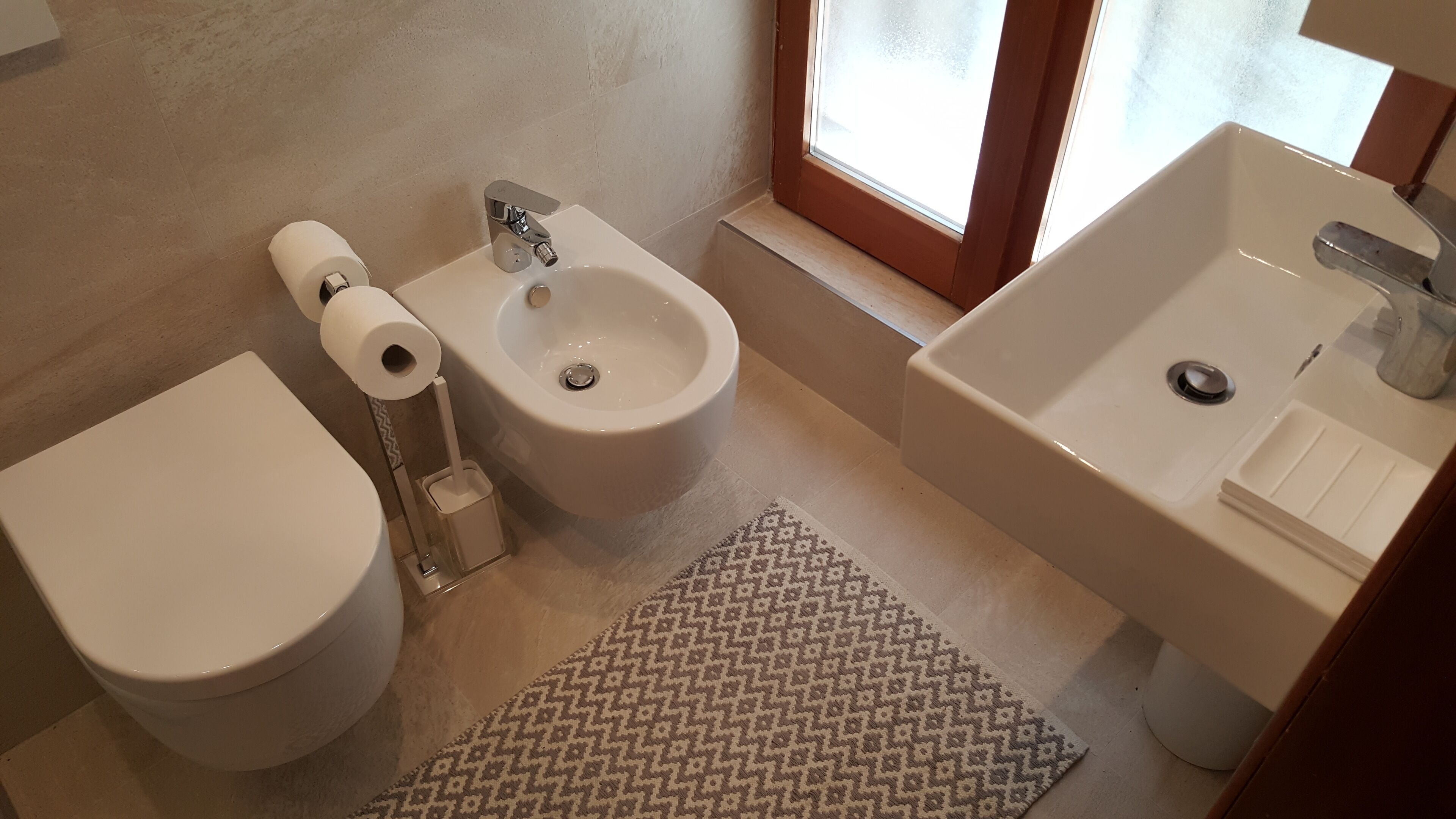 Ein Badezimmer mit Toilette, Bidet und Waschbecken.