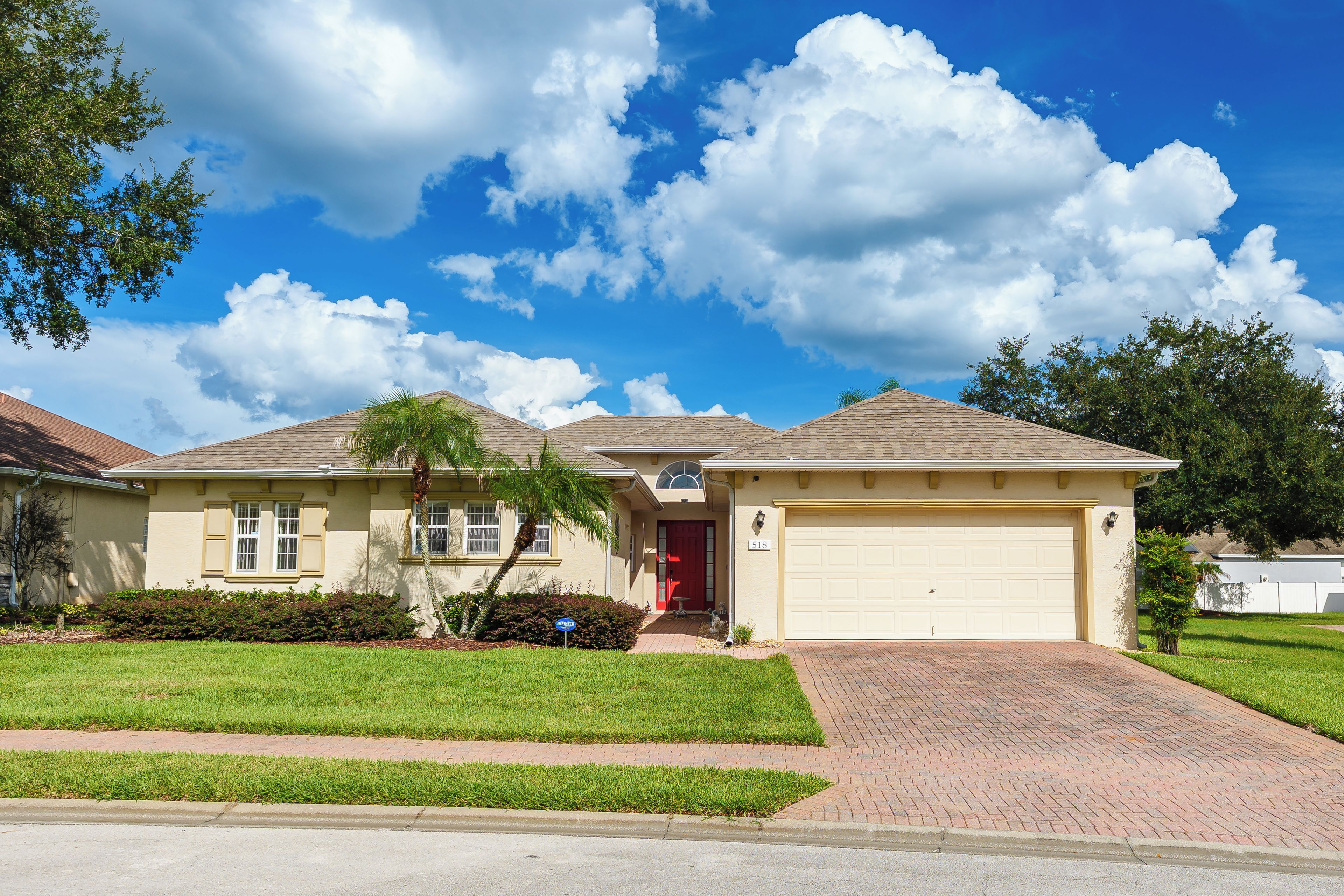 A single-story house with a garage, a front yard, and a clear sky.