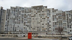 A multi-story residential building with a unique architectural design featuring circular windows and balconies. - Empuriabrava apart. First line of the sea, central, Wifi, Air conditioning.  (Empuriabrava)