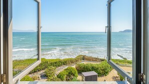 An open window with a view of the ocean and a small building in the foreground. - As seen on TV! Luxurious Beach Front Cottage with Hot Tub, Log Burner & Sea Views (Charlestown)