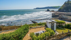 A coastal view with a rocky shoreline, a small building labeled 'The Lookout', and a clear sky. - As seen on TV! Luxurious Beach Front Cottage with Hot Tub, Log Burner & Sea Views (Charlestown)