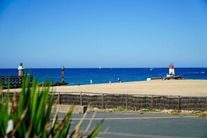 A coastal scene with lighthouses and a sandy beach.