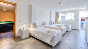 A hotel room with two beds, a pool table, and a window with curtains. - Full private villa - 300sqm Hammam Jacuzzi Heated Pool Billiard BBQ - Ideal & quiet location (Albufeira)