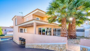 A two-story house with a stone foundation, a tiled roof, and a palm tree in the yard. - Full private villa - 300sqm Hammam Jacuzzi Heated Pool Billiard BBQ - Ideal & quiet location (Albufeira)