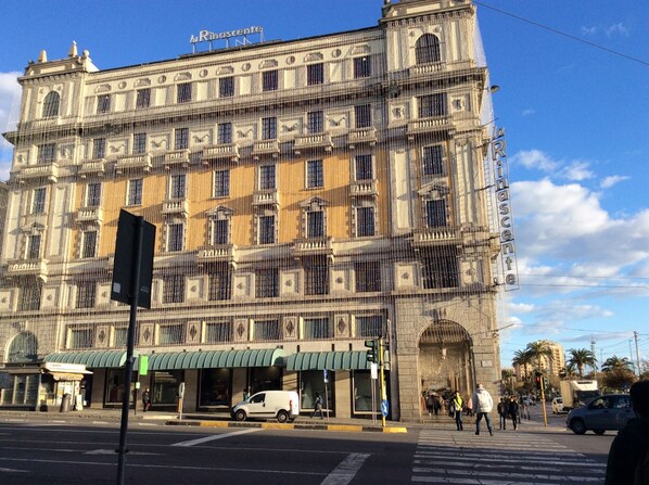 A historic building with a classic architectural style, featuring multiple windows and a prominent entrance.