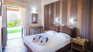 A hotel room with a large bed, a desk, and a view of the outdoors. - Luxurious villa, idyllic view, 5km from town & beach, total privacy, large pool (Rethimno)